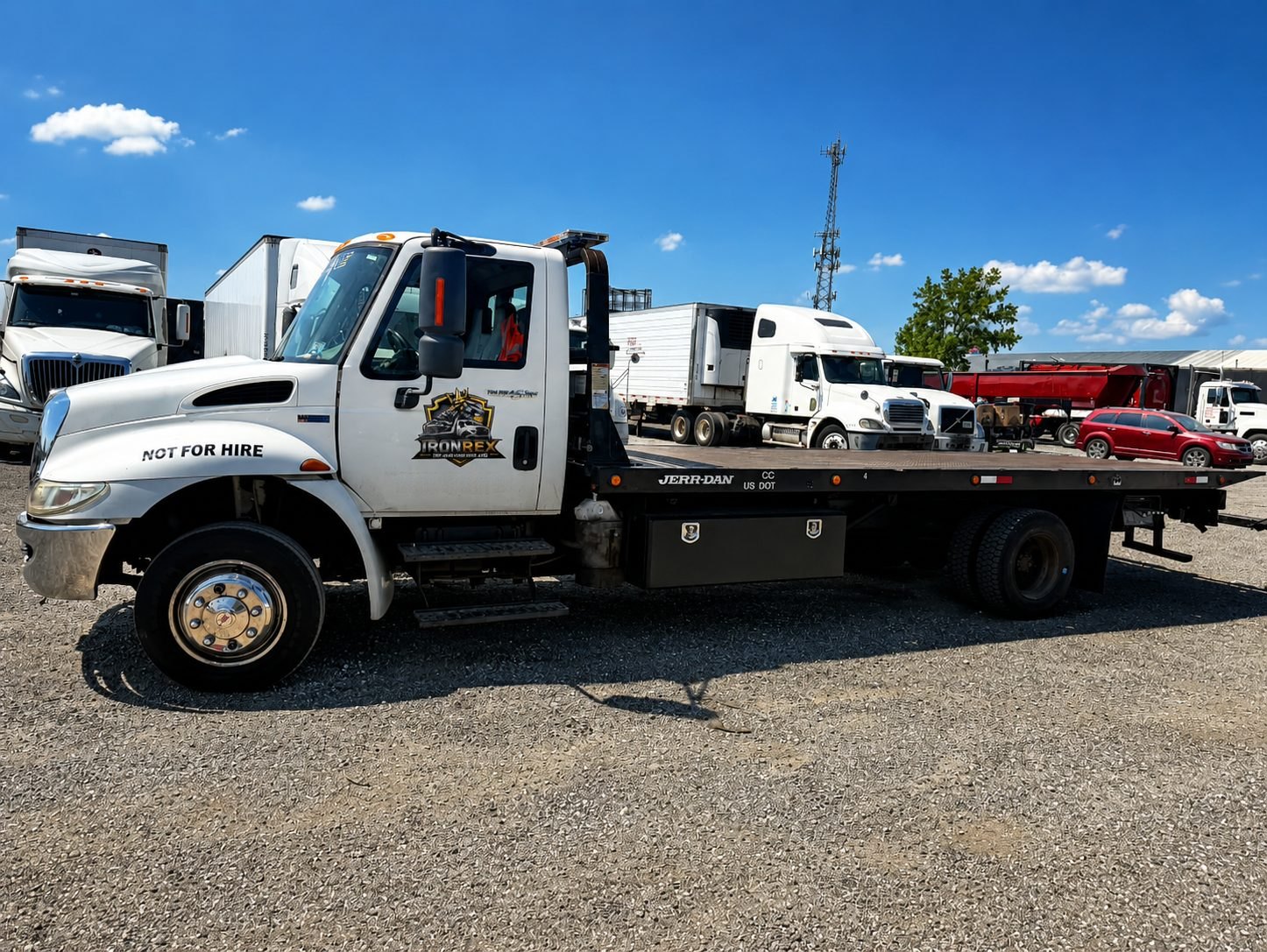 IronRex flatbed tow truck used for free junk car removal